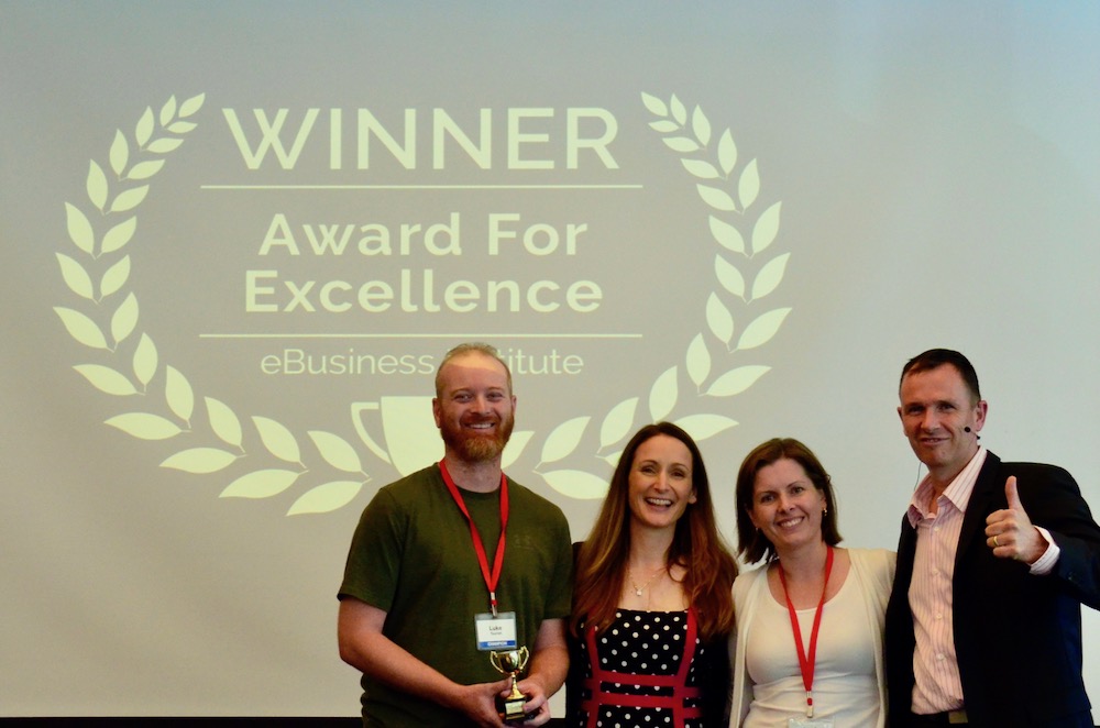 Luke Tourish and Leah Tourish winning digital marketing award from Matt Raad and Liz Raad