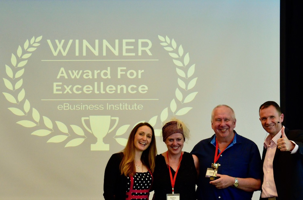 Robert Rushford and Kathie Baker winning digital marketing award from Matt Raad and Liz Raad